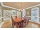 Charming dining area with hardwood floors, decorative lighting, and large windows at 2740 Heritage Bend Sw Ct, Grayson, GA 30017