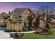 Elegant brick home with manicured lawn, mature trees and a side-entry driveway at 2740 Heritage Bend Sw Ct, Grayson, GA 30017