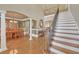 Open foyer featuring hardwood floors, staircase with iron spindles, and elegant dining area at 2740 Heritage Bend Sw Ct, Grayson, GA 30017