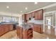 Spacious kitchen with stainless steel appliances, granite countertops, tile backsplash, and dark wood cabinets at 2740 Heritage Bend Sw Ct, Grayson, GA 30017