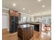 Well-lit kitchen with stainless steel appliances, granite countertops, wood cabinets, and hardwood floors at 2740 Heritage Bend Sw Ct, Grayson, GA 30017
