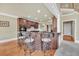 Kitchen island with seating provides views of the kitchen, stairs, and dining area with wood floors at 2740 Heritage Bend Sw Ct, Grayson, GA 30017
