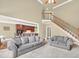 Spacious living room with comfortable seating, a view into the kitchen, and staircase access at 2740 Heritage Bend Sw Ct, Grayson, GA 30017