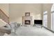 A spacious living room features a fireplace, large windows, and a staircase with iron spindles at 2740 Heritage Bend Sw Ct, Grayson, GA 30017
