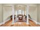 Formal living room with hardwood floors, columns, large windows and traditional furnishings at 2740 Heritage Bend Sw Ct, Grayson, GA 30017