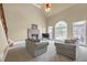 Bright living room with a stone fireplace, neutral furnishings, and large windows at 2740 Heritage Bend Sw Ct, Grayson, GA 30017