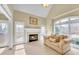 Comfortable living room with a fireplace, many windows and neutral decor at 2740 Heritage Bend Sw Ct, Grayson, GA 30017