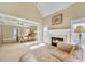 Bright main bedroom with a sitting area, fireplace, and four-poster bed at 2740 Heritage Bend Sw Ct, Grayson, GA 30017