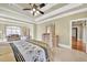 Bright main bedroom with a sitting area, four-poster bed and large windows at 2740 Heritage Bend Sw Ct, Grayson, GA 30017