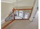 Elegant staircase with wooden railings and wrought iron spindles overlooking the living room at 2740 Heritage Bend Sw Ct, Grayson, GA 30017