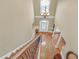 Staircase landing overlooking hardwood floors, pillars, and front door at 2740 Heritage Bend Sw Ct, Grayson, GA 30017