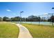 Pathway to the well-maintained tennis courts, offering a great recreational space for residents at 2740 Heritage Bend Sw Ct, Grayson, GA 30017