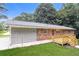 Brick home exterior with wooden deck and attached garage at 4820 Oak Grove Dr, Cumming, GA 30040