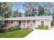 Charming single-story home with a well-maintained lawn and classic brick accents at 4820 Oak Grove Dr, Cumming, GA 30040