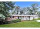 Inviting single-story home featuring a lush green lawn and mature trees at 4820 Oak Grove Dr, Cumming, GA 30040