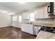 Bright kitchen featuring stainless steel appliances, granite countertops, and hardwood floors at 4820 Oak Grove Dr, Cumming, GA 30040