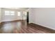 Open-concept living area featuring sleek hardwood flooring, light walls, and access to kitchen at 4820 Oak Grove Dr, Cumming, GA 30040