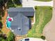 Aerial view of a two-story home with a dark roof, lush landscaping, and a large private pool at 124 White Oak Trl, Cumming, GA 30028