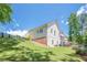 Lush backyard with a view of the house, lawn and trees at 124 White Oak Trl, Cumming, GA 30028