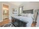 This bedroom has a ceiling fan, hardwood floors, and an ensuite bathroom at 124 White Oak Trl, Cumming, GA 30028