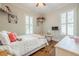 Well-lit bedroom features hardwood floors, closet, and white wood trim at 124 White Oak Trl, Cumming, GA 30028