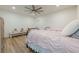 Bright bedroom featuring a bed, dresser, and ceiling fan at 124 White Oak Trl, Cumming, GA 30028