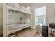 Bright bedroom featuring a bunk bed and a window at 124 White Oak Trl, Cumming, GA 30028