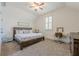 This bedroom has carpet, a desk, and a ceiling fan at 124 White Oak Trl, Cumming, GA 30028