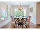 Cozy dining room with hardwood floors and many windows bringing in lots of natural light at 124 White Oak Trl, Cumming, GA 30028