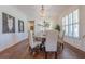 Elegant dining room with wood floors, wainscoting, stylish chandelier, and plantation shutters at 124 White Oak Trl, Cumming, GA 30028