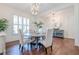 Bright dining area with wood floors, wainscoting, and views of the foyer at 124 White Oak Trl, Cumming, GA 30028