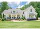 Beautiful modern farmhouse with a well-manicured lawn, covered porch, and professionally landscaped yard at 124 White Oak Trl, Cumming, GA 30028