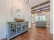 Entryway featuring hardwood floors, decorative mirror, and view into the living room at 124 White Oak Trl, Cumming, GA 30028
