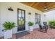 Beautiful front door framed by ferns, rocking chairs, and a brick porch at 124 White Oak Trl, Cumming, GA 30028