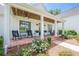 Charming front porch with brick floor, white columns, and classic rocking chairs at 124 White Oak Trl, Cumming, GA 30028