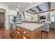 Spacious kitchen includes a large island with stainless steel sink and view into the living room at 124 White Oak Trl, Cumming, GA 30028