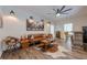 Vintage living room with unique art, a ceiling fan, and a cowhide rug at 124 White Oak Trl, Cumming, GA 30028