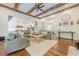 Cozy living room with exposed beams, hardwood floors, and open access to the kitchen at 124 White Oak Trl, Cumming, GA 30028