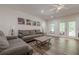 Comfortable living room with wood floors, ceiling fan and outdoor access at 124 White Oak Trl, Cumming, GA 30028
