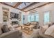 Bright living room boasts wooden beams, fireplace, built-in shelves, and view to the backyard at 124 White Oak Trl, Cumming, GA 30028