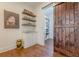 Pantry area features floating shelves, white cabinets, granite counters, and barn door access at 124 White Oak Trl, Cumming, GA 30028