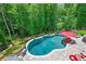Aerial view of an in-ground pool surrounded by lush greenery at 124 White Oak Trl, Cumming, GA 30028