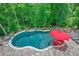 Aerial view of an in-ground pool with stone trim and surrounding patio at 124 White Oak Trl, Cumming, GA 30028