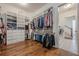 A spacious walk-in closet with custom shelving leading to the laundry room at 124 White Oak Trl, Cumming, GA 30028