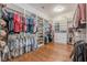 A spacious walk-in closet with custom built-in shelving and wooden floors at 124 White Oak Trl, Cumming, GA 30028