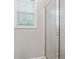 Bathroom with white tiled shower and window with blinds at 1679 Summit Place Way, Loganville, GA 30052