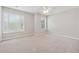 Spacious bedroom featuring plush carpet, a ceiling fan, and multiple windows for bright, natural light at 1679 Summit Place Way, Loganville, GA 30052