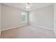 Neutral bedroom featuring plush carpet, a ceiling fan, and a window letting in natural light at 1679 Summit Place Way, Loganville, GA 30052