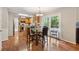 Cozy breakfast area featuring hardwood floors, table with seating, and view of kitchen and outside access at 1679 Summit Place Way, Loganville, GA 30052