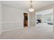 Neutral dining room with carpet, baseboard trim, and view of kitchen with natural light at 1679 Summit Place Way, Loganville, GA 30052